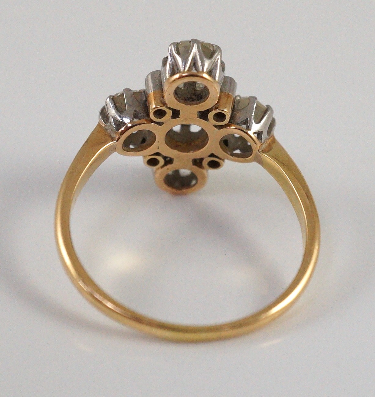A gold and old cut five stone diamond set 'cross' ring, with diamond chip set spacers